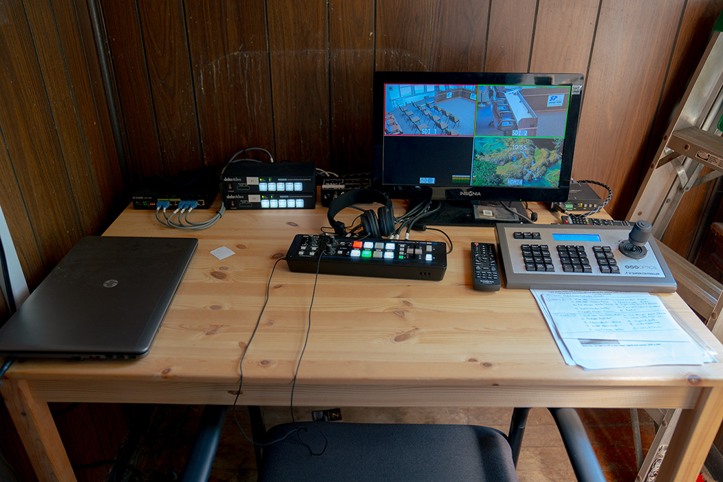 A livestream broadcast setup atop a wooden table.