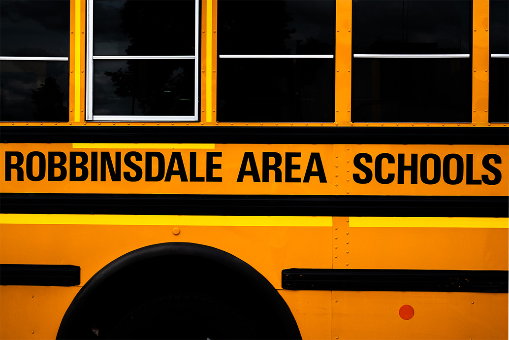A yellow school bus with "Robbinsdale Area Schools" boldly printed on the side.