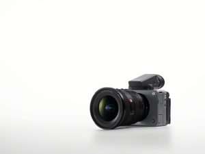 A promotional image showcasing the Sony FX5. The camera is on a white background showing the front of the camera.