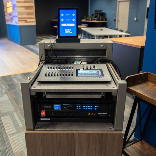A tablet is shown with the Best Buy logo atop a Lecturn. Inside are components that change what is displayed on the LED video wall installation.